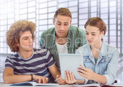 Students looking at tablet in front of blurred background