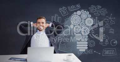 Happy business man at a desk sitting against blue background with graphics