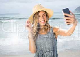Woman taking casual selfie photo in front of sea