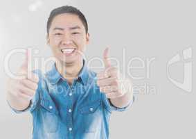 Portrait of Man giving thumbs up with grey background