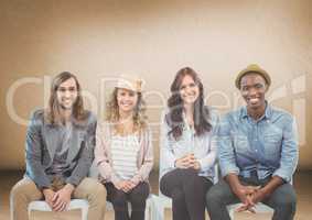 Group of people sitting in front of brown background