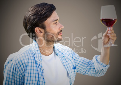 Man tasting wine against brown background