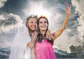 Women taking casual selfie photo in front of dramatic sky