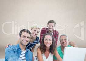 Group of people on laptop in front of brown background