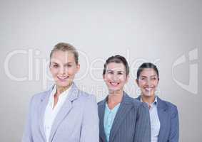 Group of businesswomen standing in front of grey background
