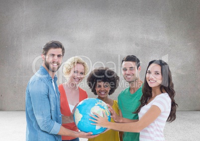 Group of people holding world globe in front of grey background
