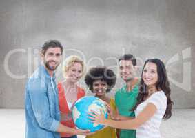 Group of people holding world globe in front of grey background