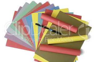 Sheets of colored paper on a white background.
