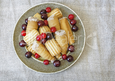 Biscuits and cherries on the plate. The view from the top