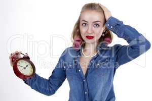 Young woman with alarm clock