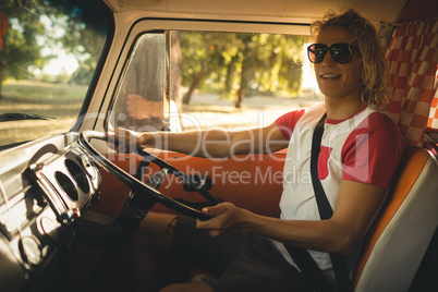 Smiling man driving camper va