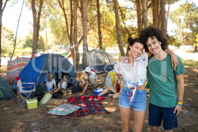 Portrait of happy couple with friends in background