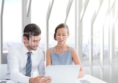 Business people at a desk looking at a computer