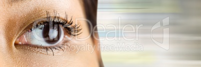 Close up of woman's eye with lens and blurry grey background