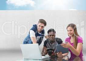 Group of people on laptop with camera in front of grey background with sky