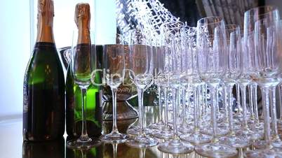 Glasses on the buffet table, a bottle of champagne, restaurant design, smooth movement of the camera along the table