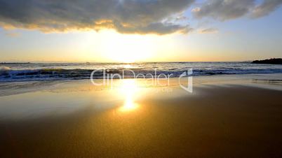 Sun reflecting off the sea on a beach, Puerto Sherry, Cadiz, Spain