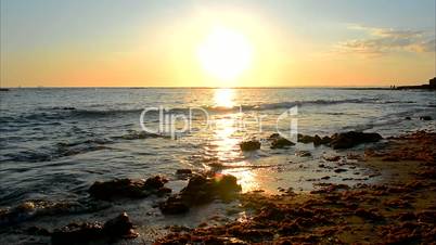 Sun reflecting off the sea on a beach, Puerto Sherry, Cadiz, Spain