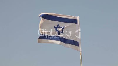 An Israeli flag waving in the breeze filmed in Israel.