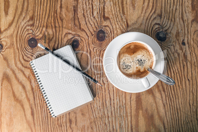 Notepad, pencil, coffee cup