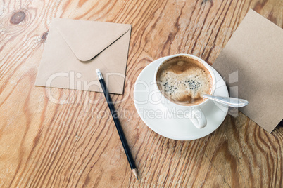 Coffee cup, pencil, envelope