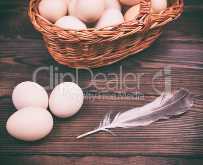 Raw chicken eggs on a wooden surface