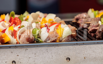 Chicken, beef and onion kabobs on a barbecue grill