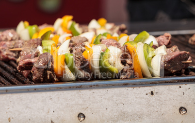Chicken, beef and onion kabobs on a barbecue grill