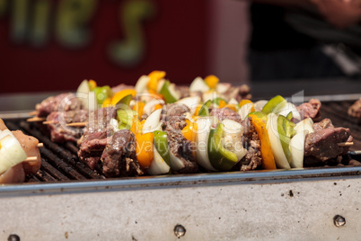 Chicken, beef and onion kabobs on a barbecue grill