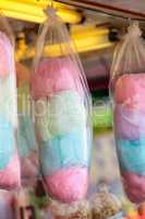 Pink, green and blue cotton candy hangs in bags