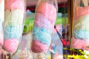 Pink, green and blue cotton candy hangs in bags