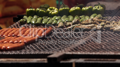 Sausage on a barbecue to cook at a fair ground.