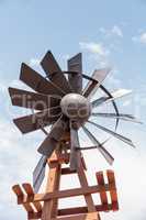 Metal windmill against a blue sky