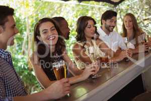 Friends interacting while having a alcohol at counter