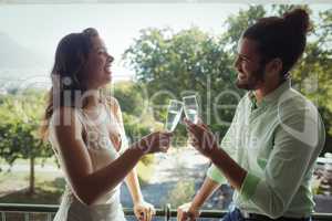 Couple toasting champagne glasses in restaurant