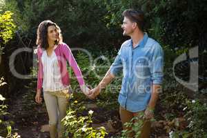 Happy couple holding hands in garden