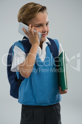 Schoolboy talking on mobile phone