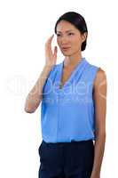 Thoughtful businesswoman looking away while gesturing
