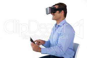 Businessman using tablet computer while wearing vr glasses