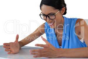 Close up of smiling businesswoman gesturing while sitting at table