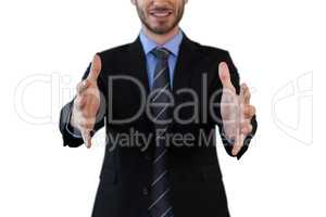 Mid section of smiling businessman in suit marketing invisible product