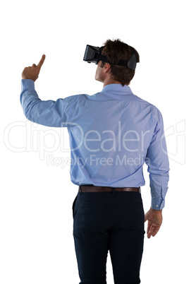 Rear view of businessman with vr glasses against white background