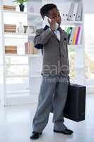 Businessman with suitcase talking on mobile phone