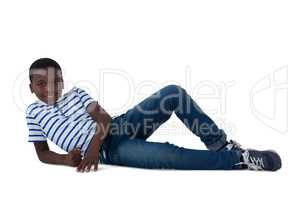 Boy lying on floor against white background