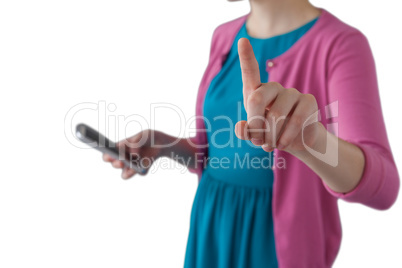 Teenage girl pressing an invisible virtual screen while using mobile phone