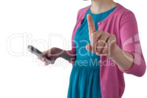 Teenage girl pressing an invisible virtual screen while using mobile phone