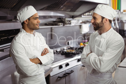 Chefs interacting with each other in kitchen