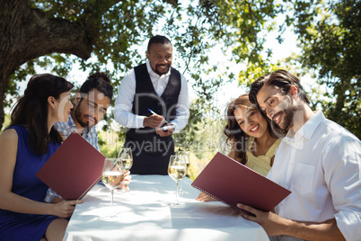 Friends placing order to waiter