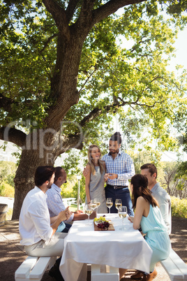 Group of friends interacting with each other while having champagne