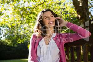 Woman sitting on bench and talking on mobile phone